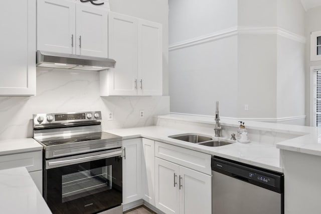 kitchen with under cabinet range hood, appliances with stainless steel finishes, white cabinets, and a sink