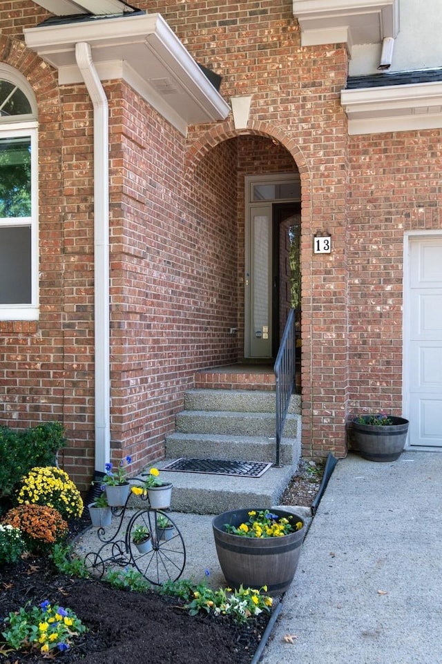 view of exterior entry with brick siding