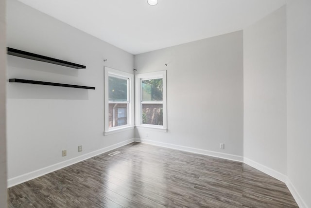 empty room with wood finished floors and baseboards