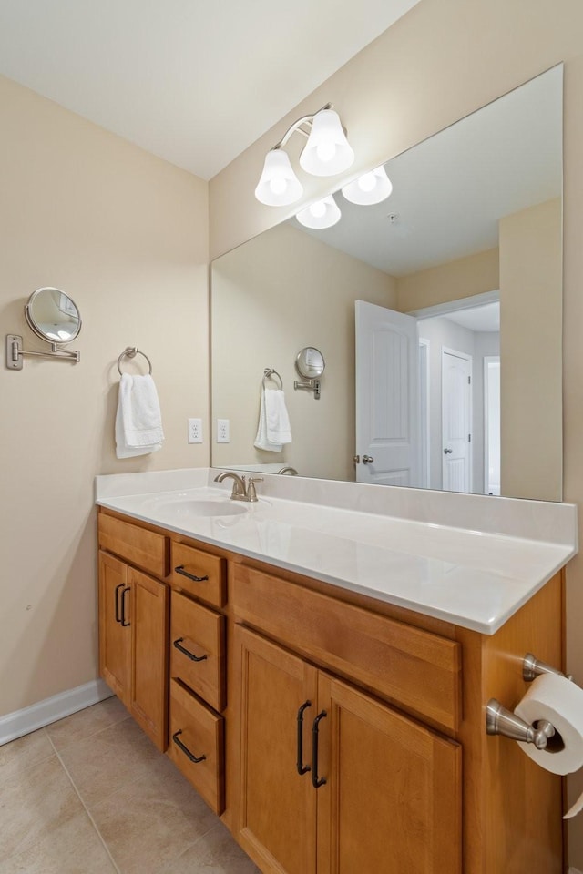 bathroom featuring tile patterned flooring, vanity, and baseboards