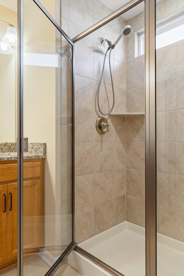 bathroom featuring vanity and a shower stall