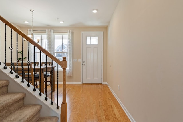 entrance foyer featuring light wood finished floors, recessed lighting, stairs, and baseboards