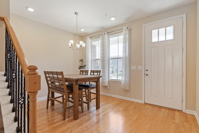 dining area featuring a notable chandelier, recessed lighting, stairway, light wood finished floors, and baseboards