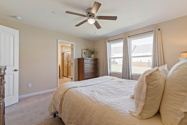 bedroom featuring ensuite bath, a ceiling fan, baseboards, and carpet floors