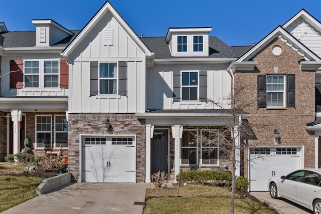 view of front of property featuring stone siding, board and batten siding, concrete driveway, an attached garage, and a shingled roof