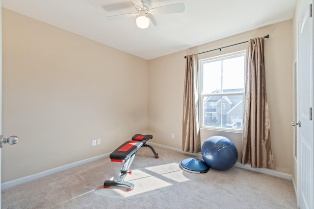 workout area with carpet flooring, a ceiling fan, and baseboards