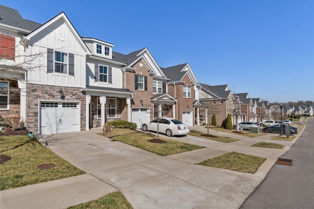 townhome / multi-family property with a residential view, board and batten siding, driveway, and a garage