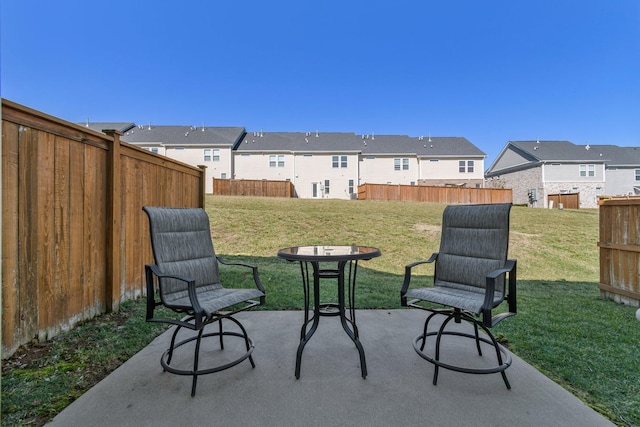 view of patio featuring a residential view and fence