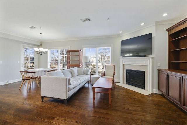 living room with visible vents, a healthy amount of sunlight, and dark wood-type flooring