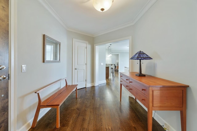 corridor featuring dark wood-type flooring, baseboards, and ornamental molding