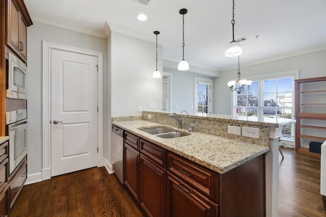 kitchen with dark wood finished floors, a peninsula, a sink, appliances with stainless steel finishes, and crown molding