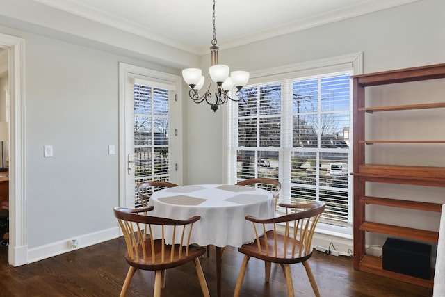 dining space featuring baseboards, a notable chandelier, dark wood-style flooring, and crown molding