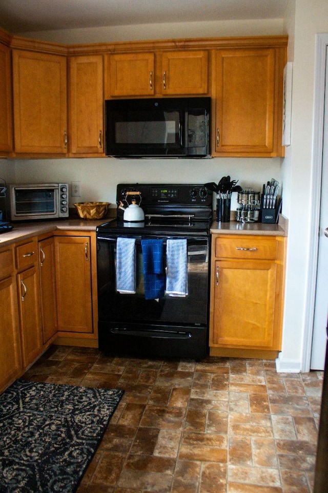 kitchen with brown cabinets, black appliances, and a toaster