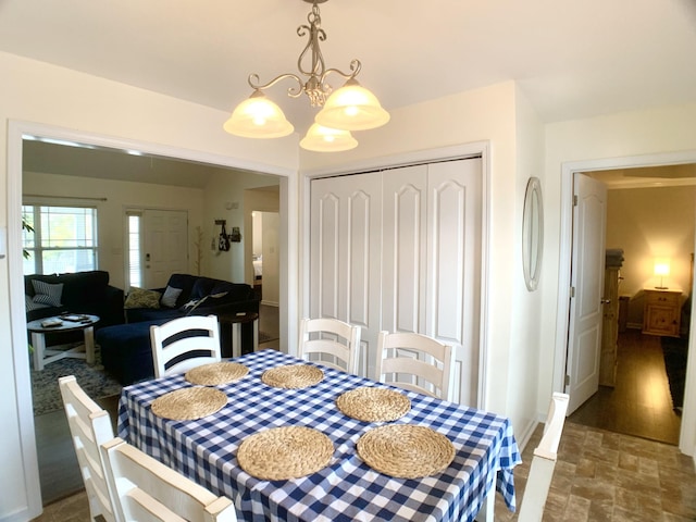 1016 Sunset Dr, Clarksville, TN 37040 - dining area with a chandelier, stone finish flooring, and baseboards