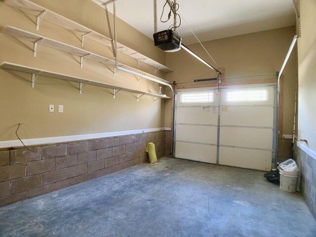 1016 Sunset Dr, Clarksville, TN 37040 - garage featuring concrete block wall and a garage door opener