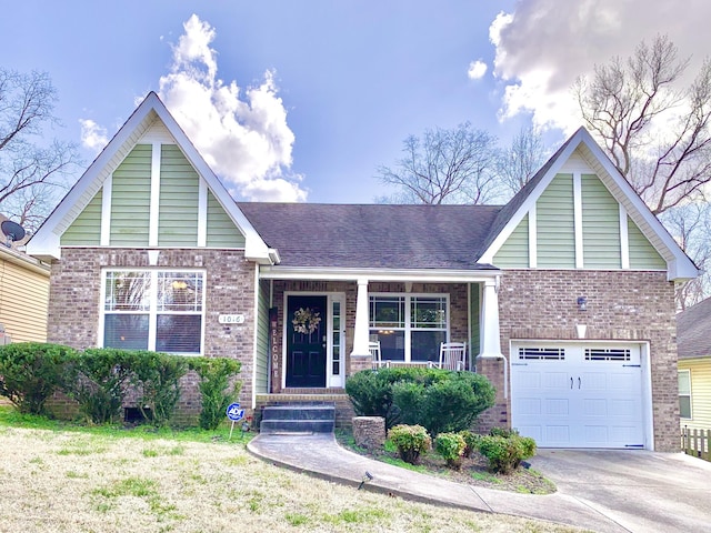 view of front of property with a garage, covered porch, brick siding, and driveway