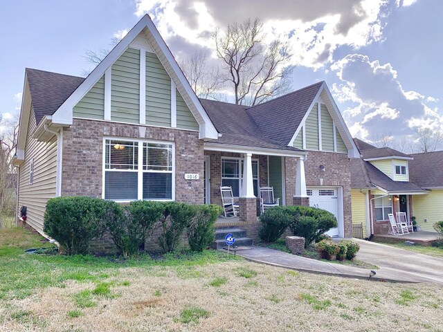 1016 Sunset Dr, Clarksville, TN 37040 - view of front of property with brick siding, covered porch, concrete driveway, and roof with shingles