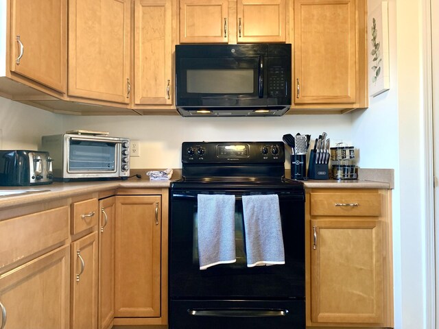 1016 Sunset Dr, Clarksville, TN 37040 - kitchen with black appliances, a toaster, and light countertops