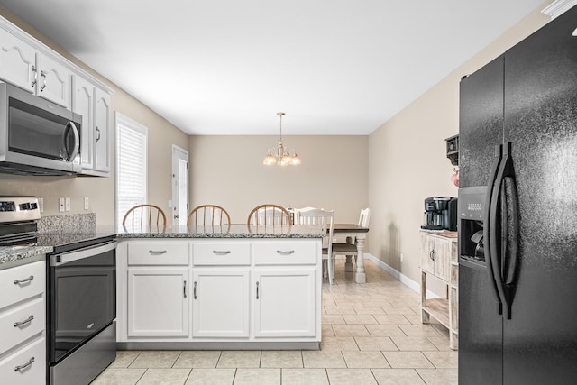 kitchen featuring a peninsula, stainless steel appliances, white cabinets, pendant lighting, and a chandelier