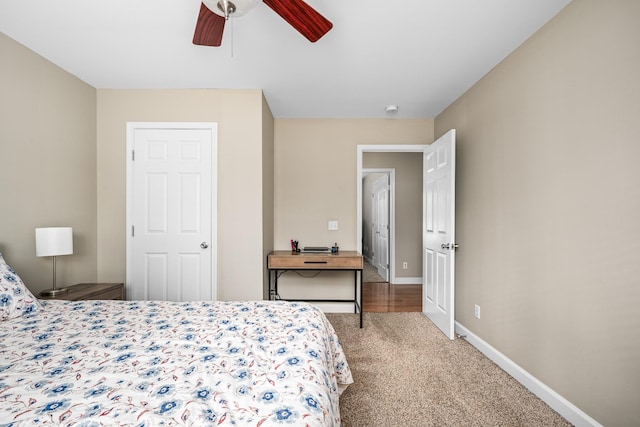 carpeted bedroom with baseboards and a ceiling fan