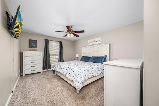 bedroom with light colored carpet, baseboards, and ceiling fan