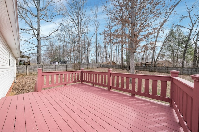 wooden terrace featuring a fenced backyard