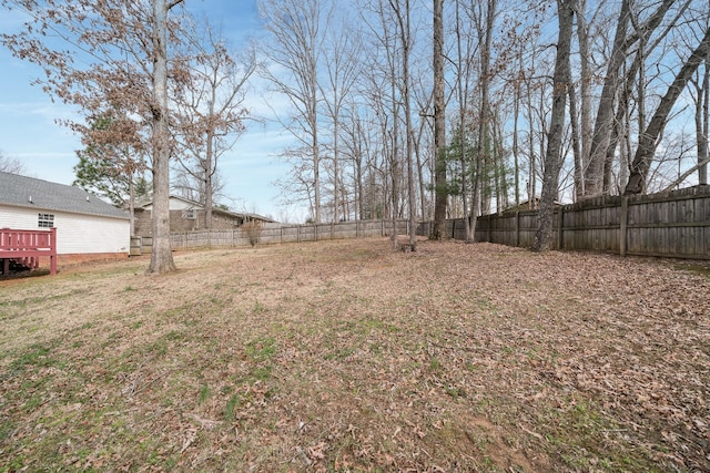 view of yard featuring a wooden deck and a fenced backyard