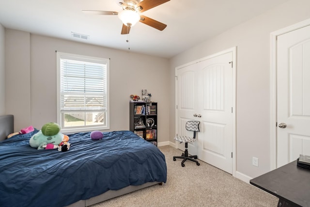 carpeted bedroom featuring visible vents, ceiling fan, and baseboards