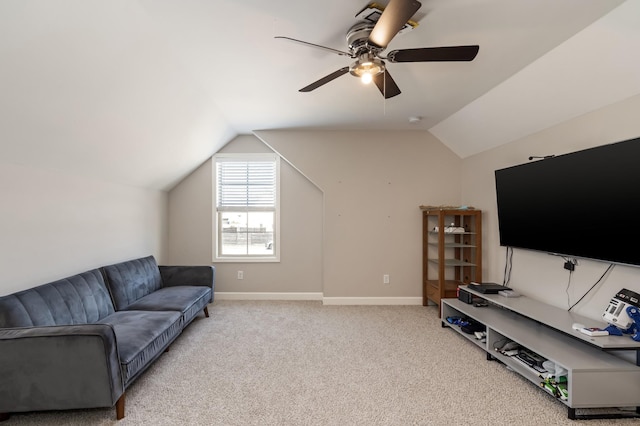 carpeted living room with baseboards, lofted ceiling, and a ceiling fan