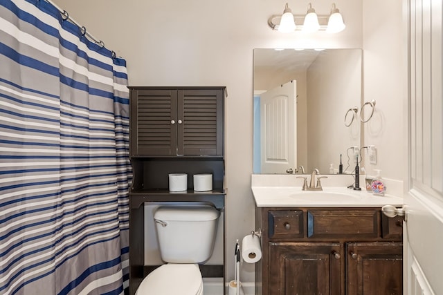 bathroom with toilet and vanity