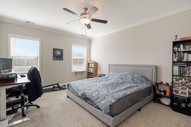 carpeted bedroom with visible vents, baseboards, ceiling fan, and ornamental molding