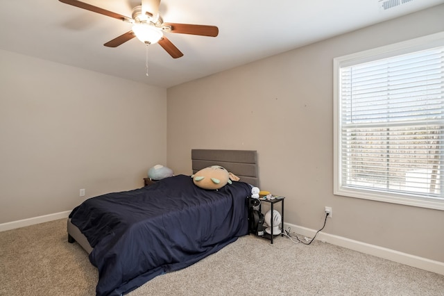 bedroom with multiple windows, baseboards, and carpet floors