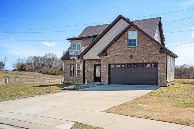 craftsman-style home with fence, concrete driveway, a front yard, a shingled roof, and brick siding