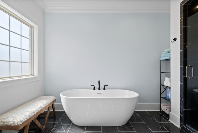 bathroom featuring baseboards, a soaking tub, ornamental molding, a shower stall, and marble finish floor