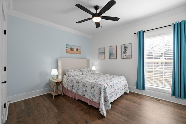 bedroom featuring dark wood-style floors, visible vents, baseboards, and ornamental molding