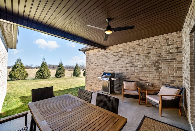 view of patio / terrace featuring area for grilling, outdoor dining space, and a ceiling fan