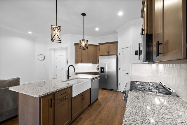 kitchen with dark wood-type flooring, light stone countertops, ornamental molding, appliances with stainless steel finishes, and a sink