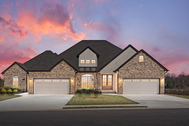 view of front facade with concrete driveway, an attached garage, brick siding, and a shingled roof