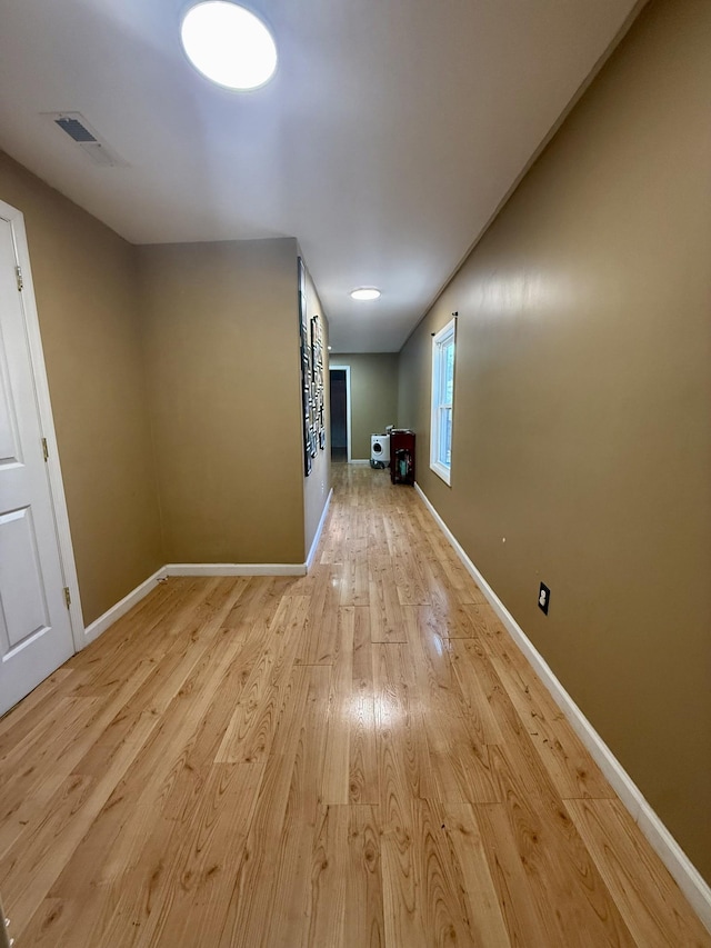 interior space featuring visible vents, baseboards, and light wood-style flooring