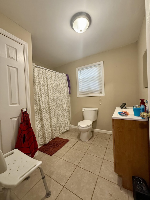 bathroom with a shower with curtain, toilet, tile patterned flooring, baseboards, and vanity