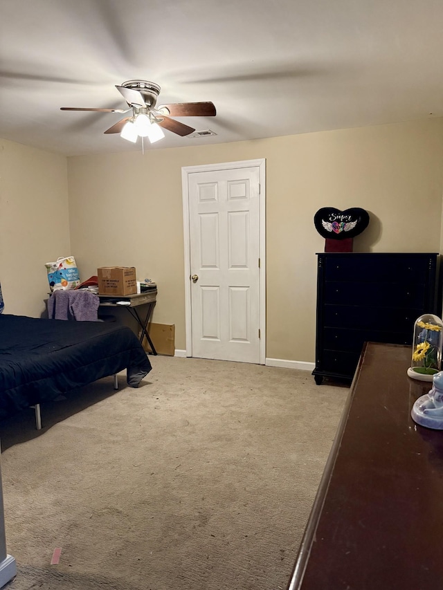 bedroom with visible vents, baseboards, carpet, and a ceiling fan