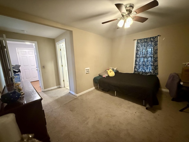 carpeted bedroom with baseboards and ceiling fan