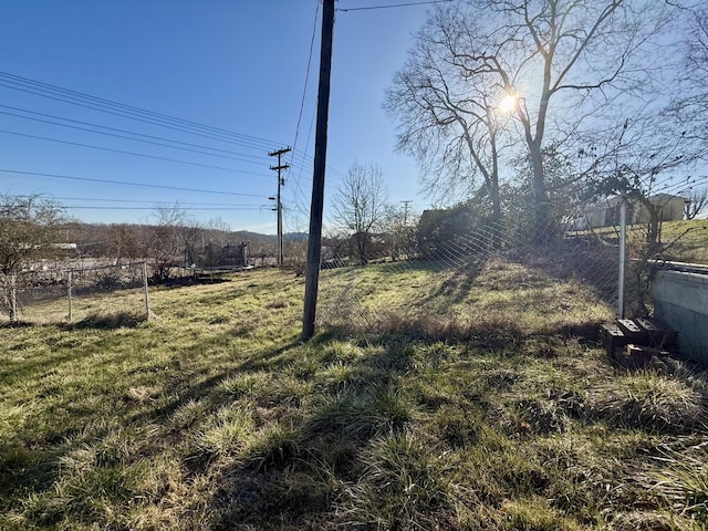 view of yard with a trampoline and fence