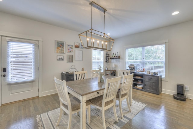 dining space with recessed lighting, an inviting chandelier, baseboards, and wood finished floors