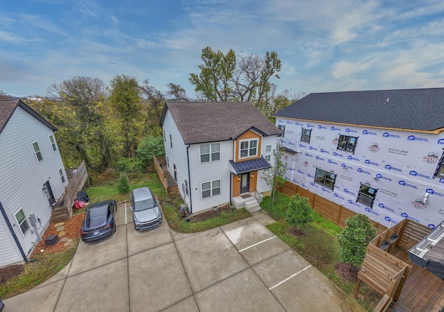 exterior space with roof with shingles and fence