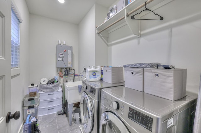 clothes washing area with tile patterned flooring, laundry area, and washing machine and clothes dryer