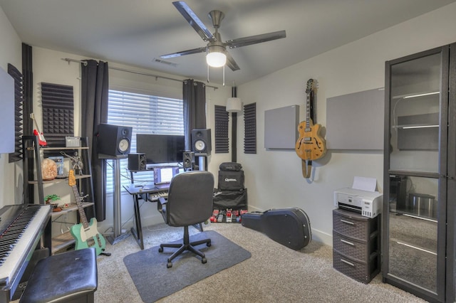 home office with a ceiling fan, visible vents, and carpet floors