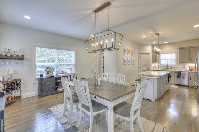 dining area with recessed lighting, baseboards, and light wood finished floors