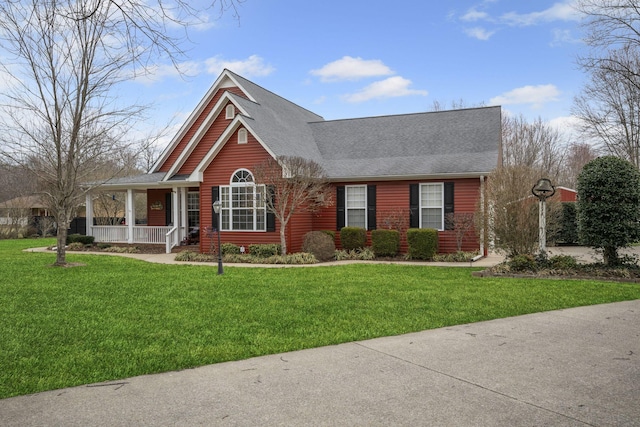 view of front facade with covered porch and a front lawn