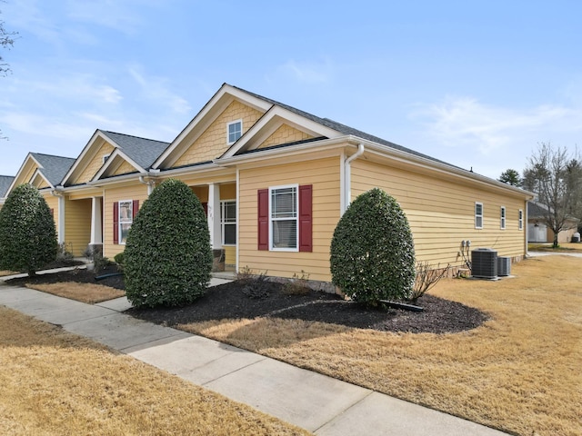 view of front of property featuring central air condition unit and a front yard